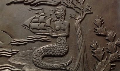 Messingplaat van grote vignette op de klok van de Antillen naar een ontwerp van Genia van der Grinten-Lücker